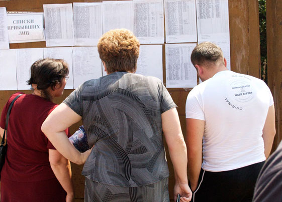 South Ossetian refugees looking at lists of missing persons IRC photo